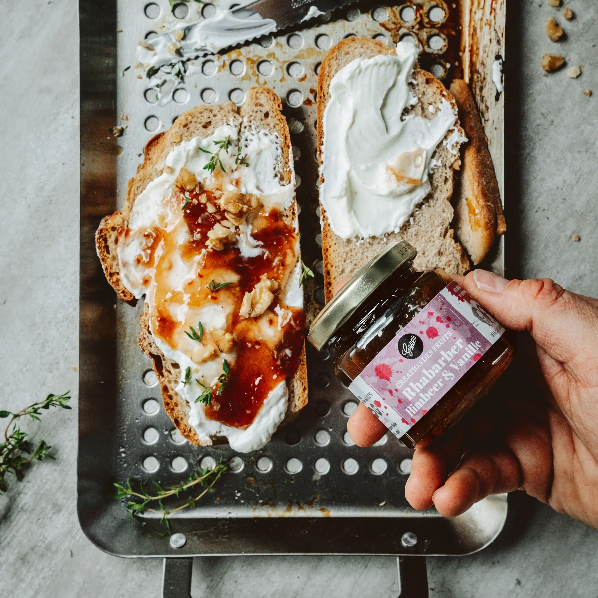Geroestetes Brot mit cremigem Frischkaese und Fruchtaufstrich Rhababer Himbeer und Vanille